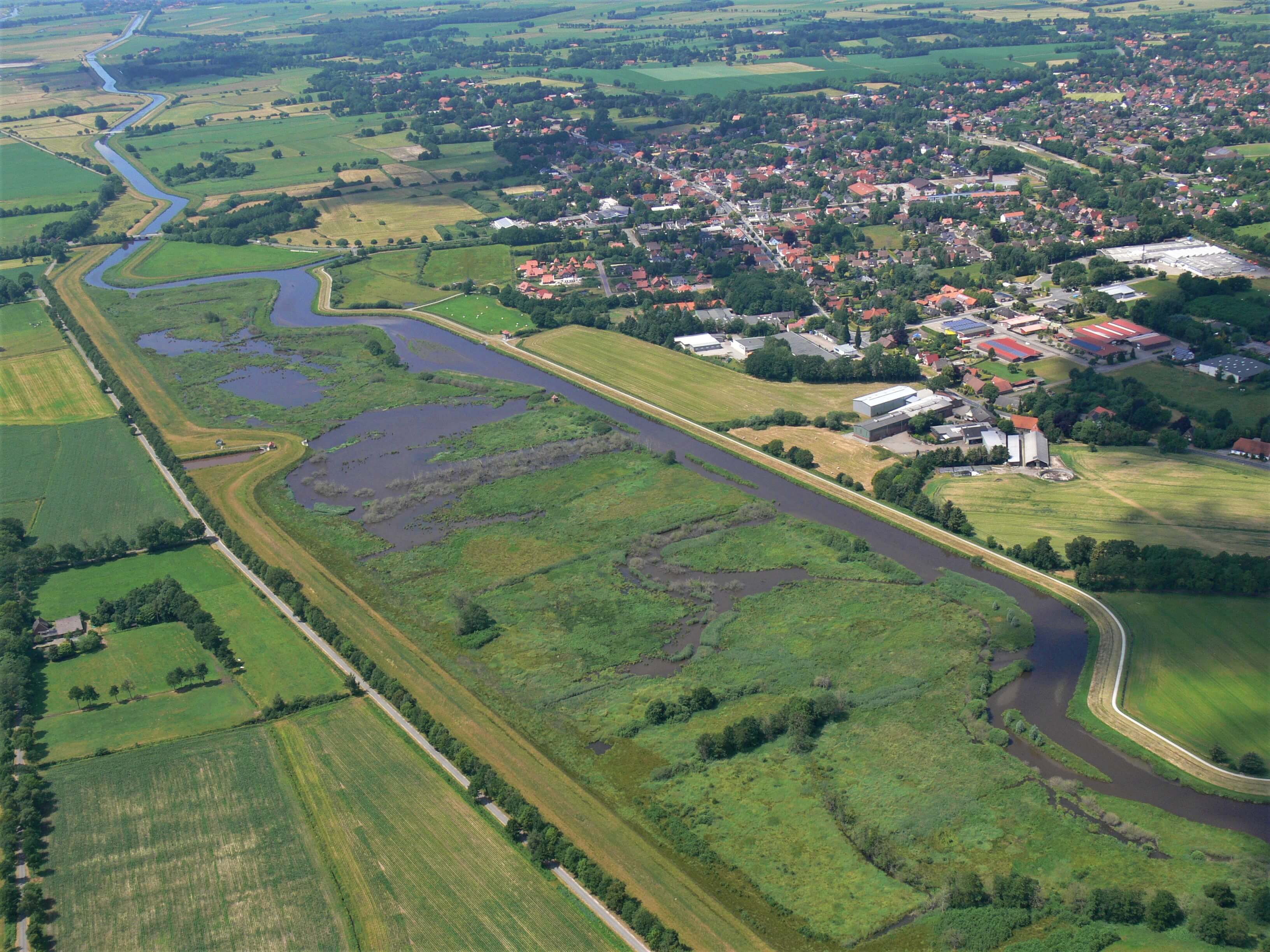 Luftaufnahme einer weitläufigen Naturlandschaft mit verschieden Wasserläufen.