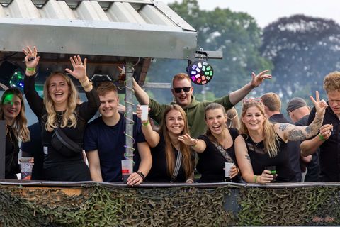 Junge Leute auf einem festlich geschmückten Wagen beim grossen Festumzug